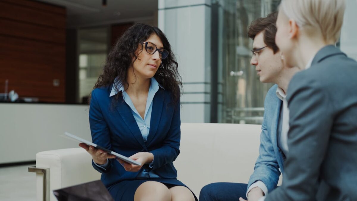 A professional meeting with a team discussing business strategies in a modern office setting.